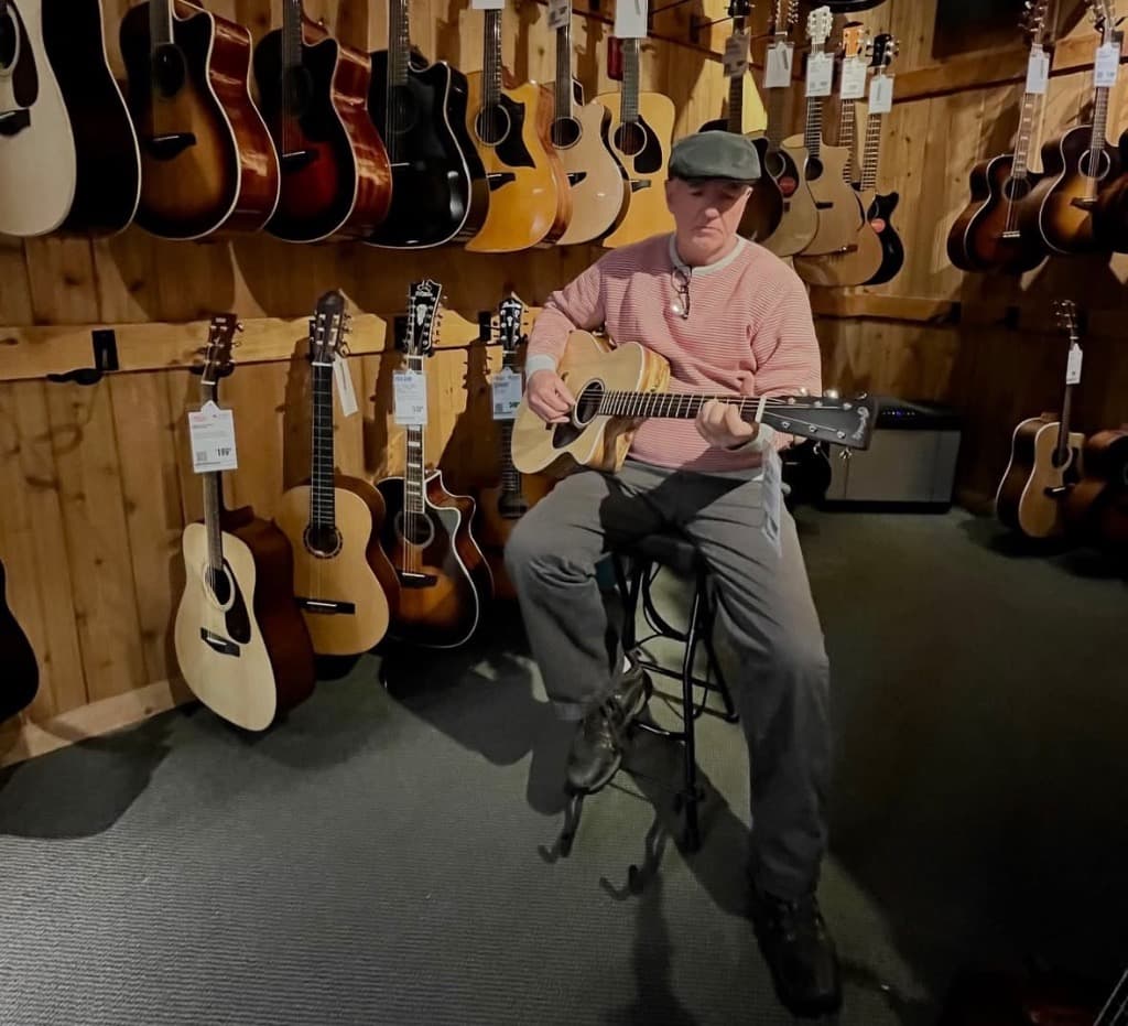 Zach MacDonald playing acoustic Martin guitar